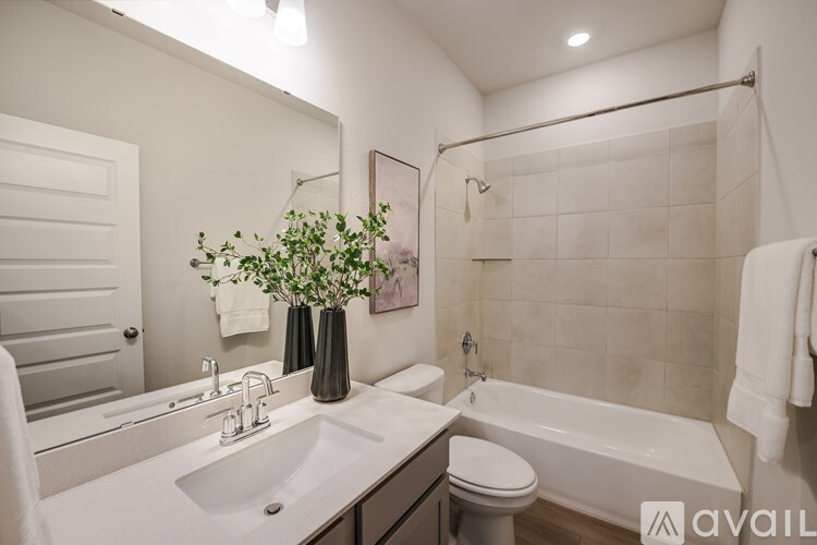 A bathroom with a white sink and a white toilet.