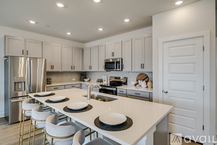 A kitchen with a white countertop and white cabinets.