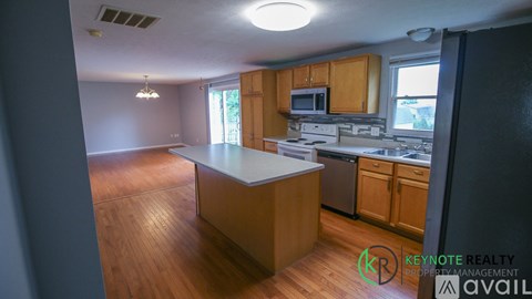 A kitchen with wooden cabinets and a white countertop.