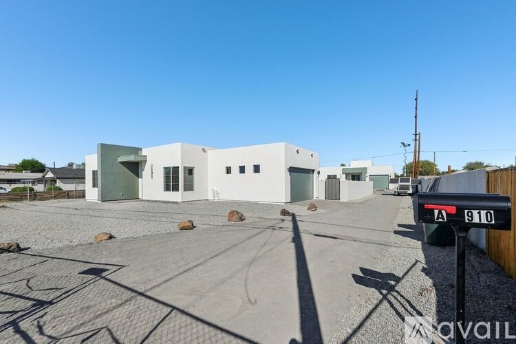 A modern building with a clear blue sky above it.
