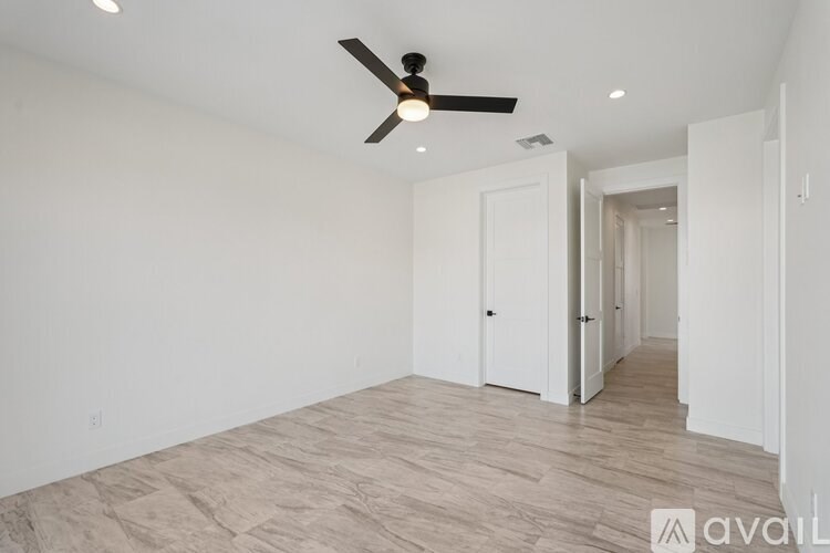 A room with a ceiling fan and lighting fixtures.
