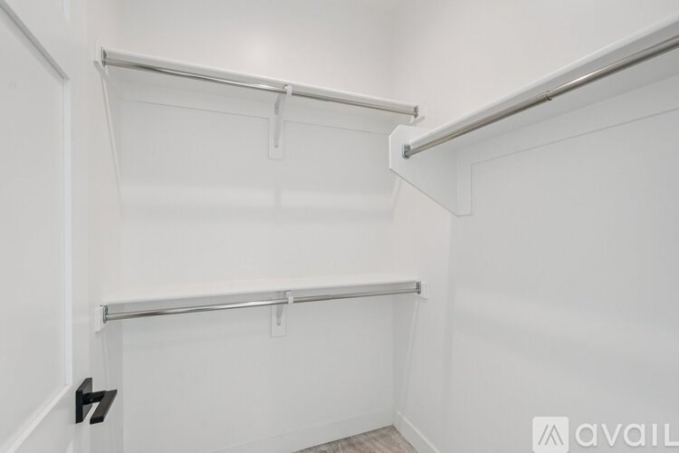 A white wall with a shelf and a black number 7 on it.