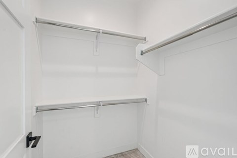 A white wall with a shelf and a black number 7 on it.