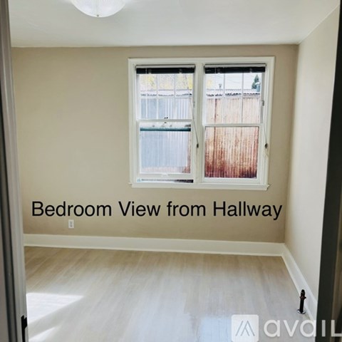 A bedroom with a view from the hallway.
