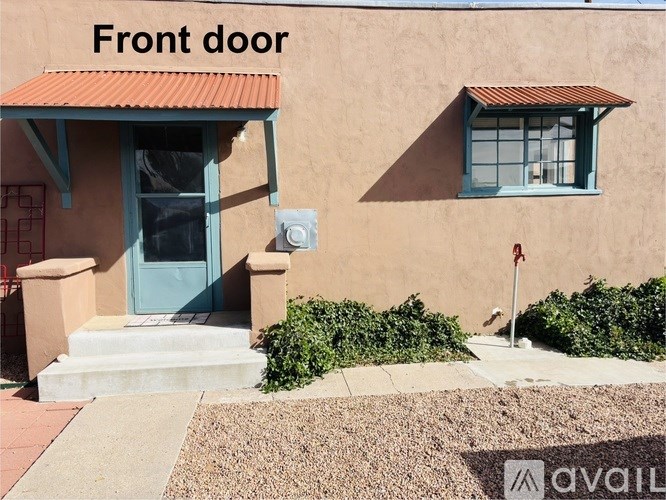 A house with a blue front door and a red roof.