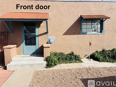 A house with a blue front door and a red roof.