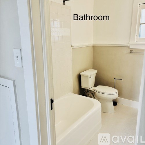 A bathroom with a toilet and a bathtub.