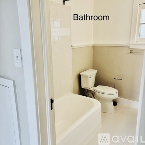 A bathroom with a toilet and a bathtub.