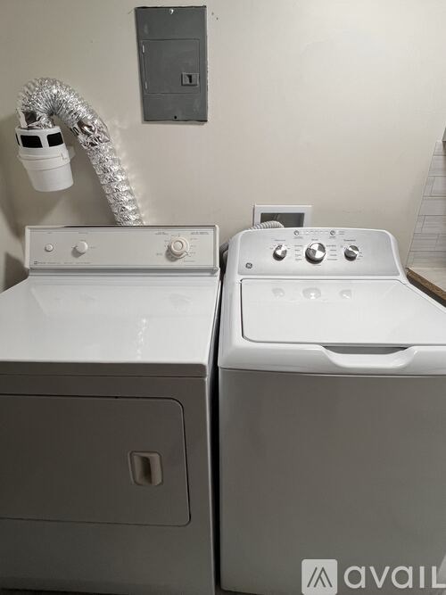 A washing machine and dryer are sitting next to each other.