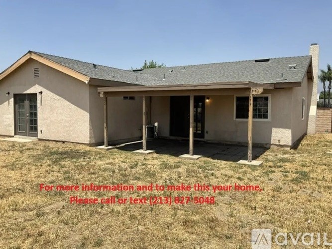 A house with a sign offering information and contact details for making it your home.