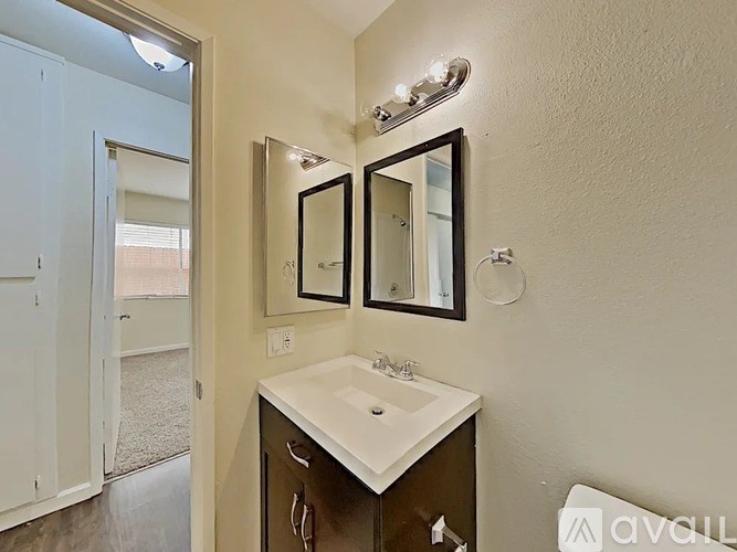 A bathroom with a sink and mirrors.