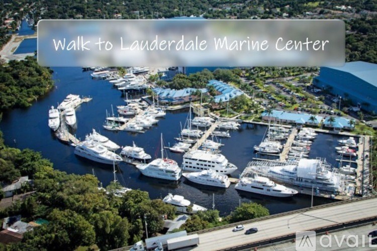 A bird's eye view of a marina with boats and a sign that says "Walk to Lauderdale Marine Center".