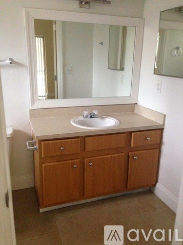 A bathroom with a sink and a mirror.