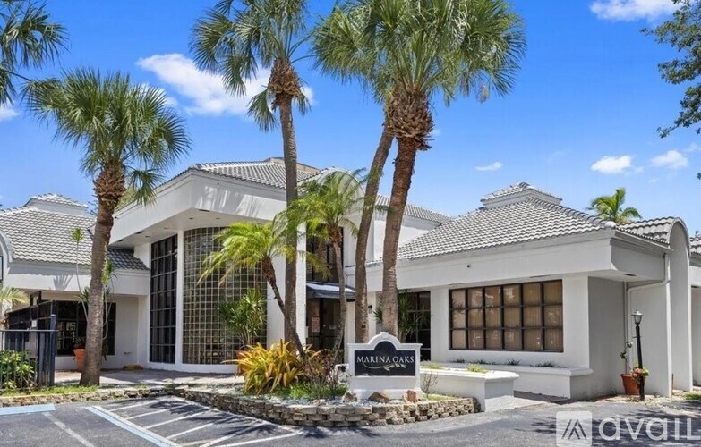 A modern house with a glass entrance and a sign that reads "Marina Ridge".