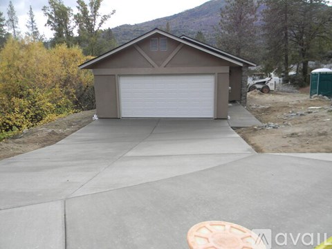 A house with a garage door is for sale.
