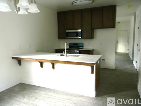 A kitchen with brown cabinets and a white countertop.