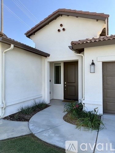 A house with a brown door and a brown roof.