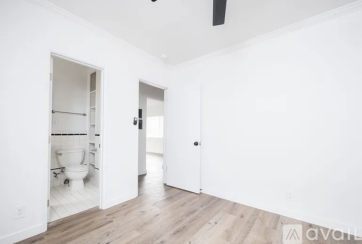 A white bathroom with a toilet and a sink.