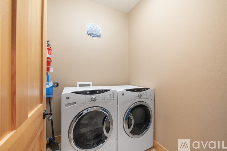 A washing machine is sitting in a small room.