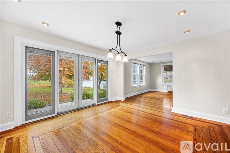 A room with wooden floors and a chandelier.