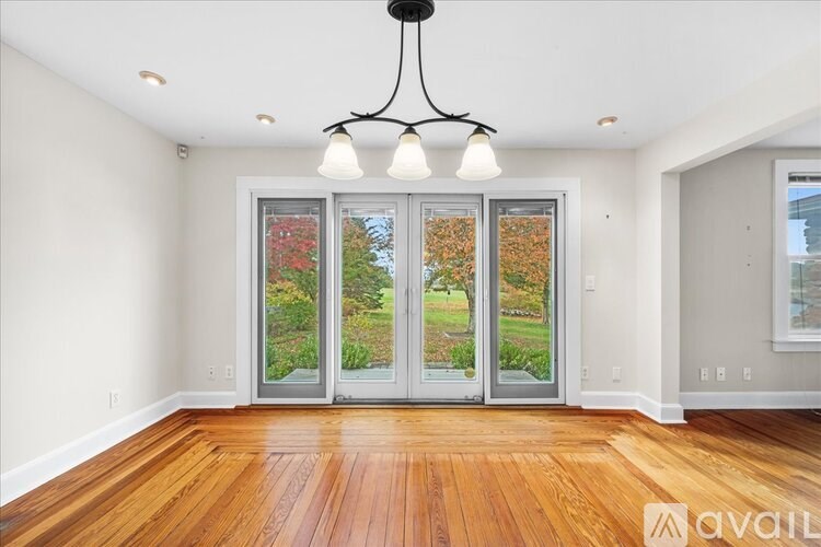 A room with a wooden floor and a chandelier.