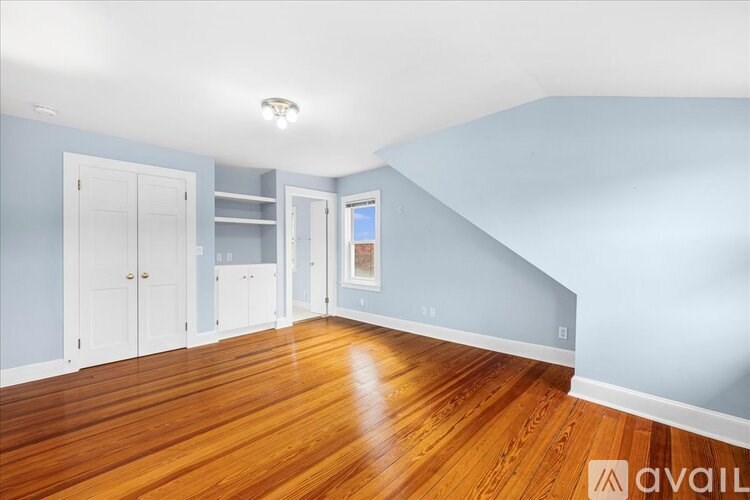 A room with wooden floors and blue walls.