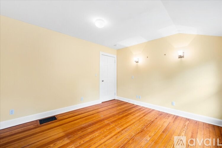 A room with wooden floors and a white door.