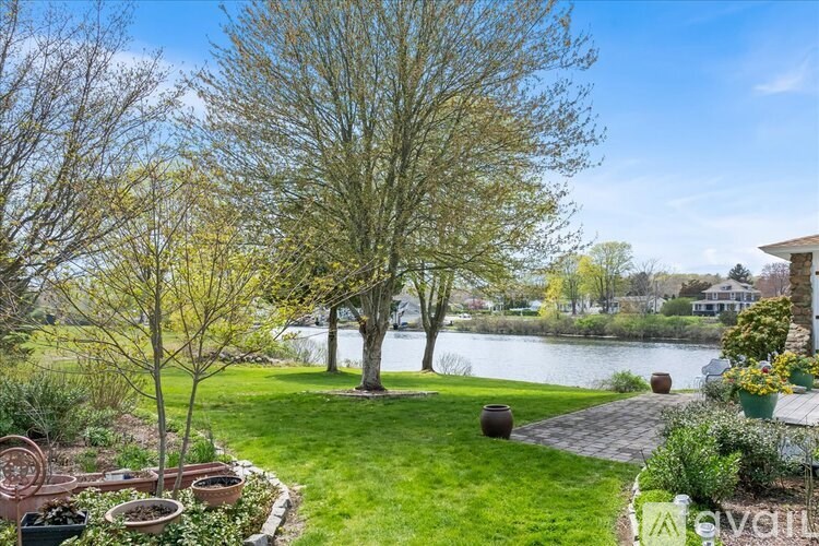 A beautiful garden with a lake in the background.