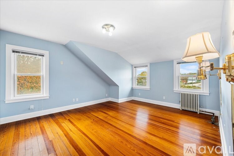A room with wooden floors and blue walls.