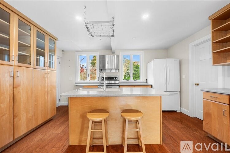 A kitchen with wooden cabinets and a white refrigerator.