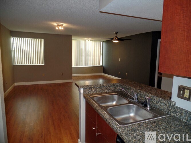 A kitchen with a granite countertop and a sink.