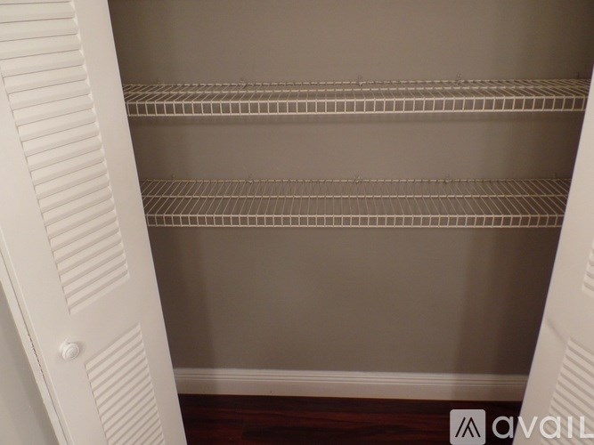 Empty white shelves in a room.