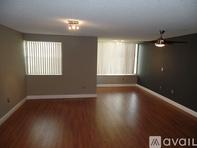A room with wooden floors and a ceiling fan.