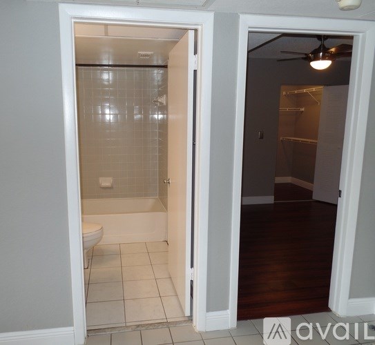 A bathroom with a toilet and a walk-in shower.