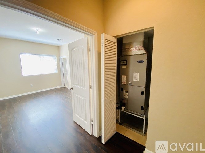 A room with a white door and a wall-mounted air conditioning unit.