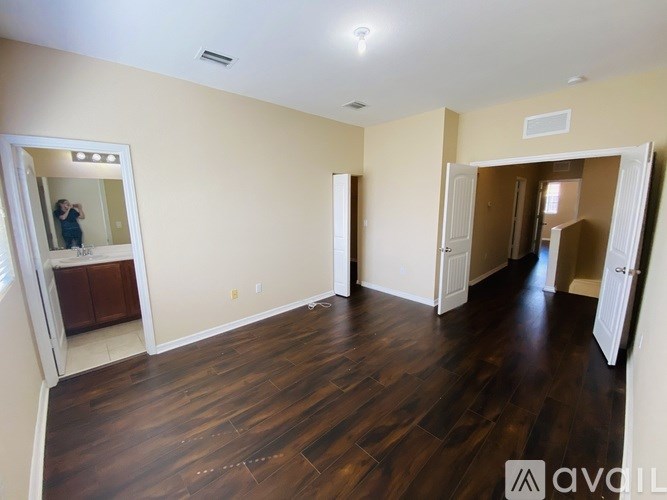 A room with wooden floors and white walls.