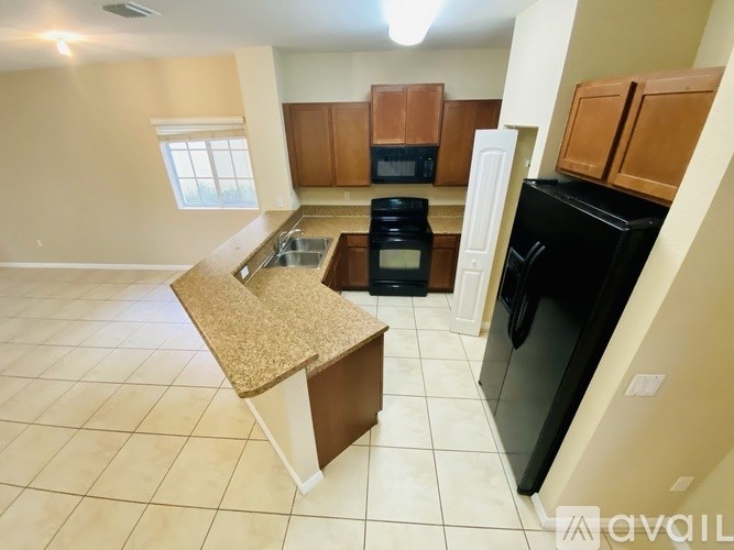 A kitchen with a black oven and a granite counter.