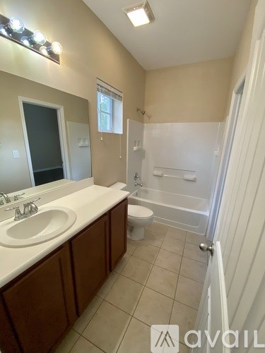 A bathroom with a sink, toilet, and bathtub.