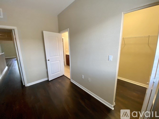 A room with a white door and a white wall.