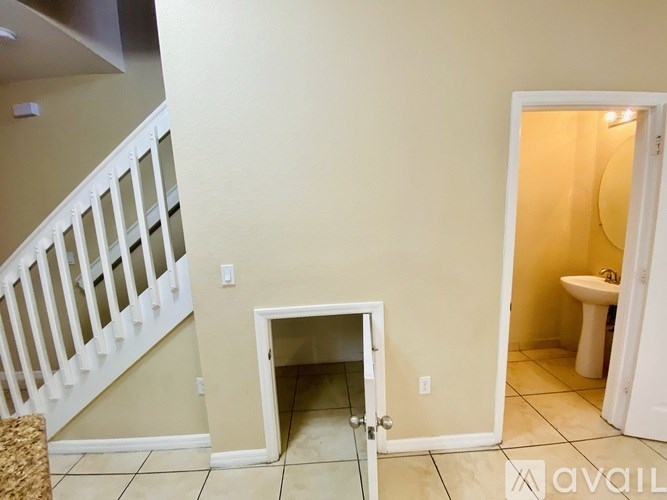 A bathroom with a toilet and sink is visible through a doorway.