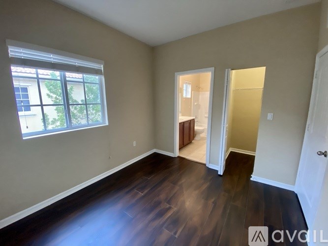 A room with wooden floors and a window.