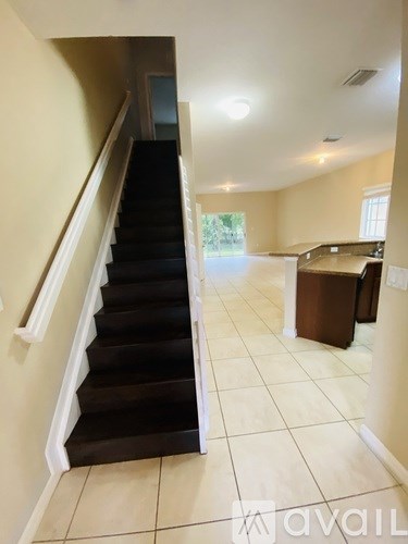 A staircase with a white railing leads to a second floor.