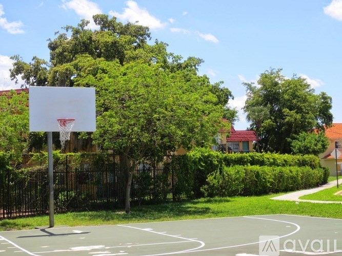 A basketball court with a white hoop and a sign that says "available".