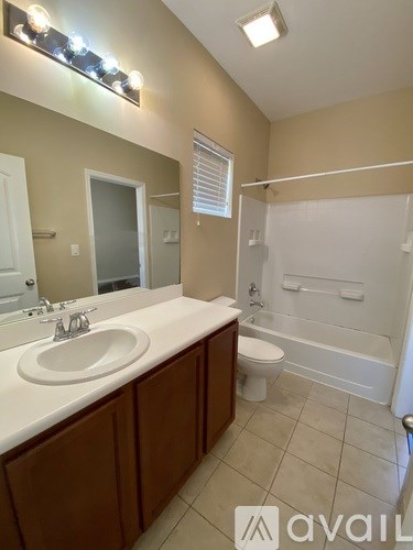 A bathroom with a sink, toilet, and bathtub.