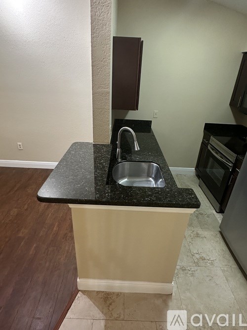A kitchen island with a sink and a counter.