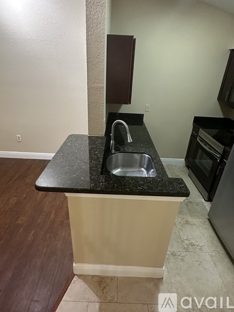 A kitchen island with a sink and a counter.