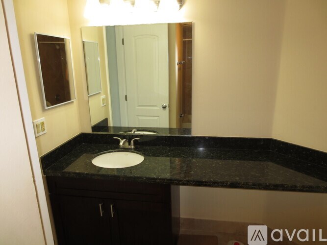 A bathroom with a sink and mirror.