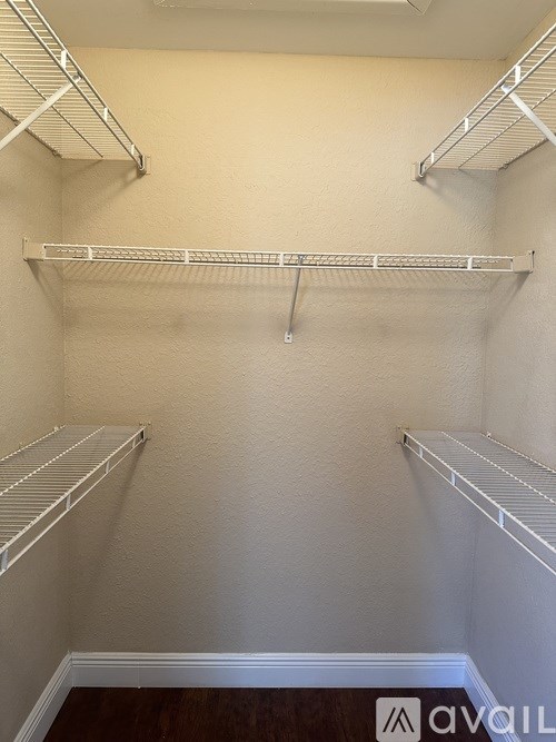 Empty white shelves in a room.