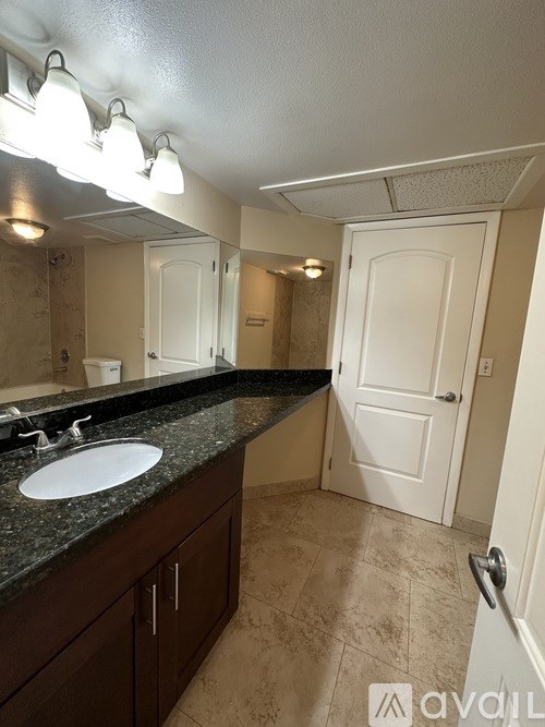 A bathroom with a sink and mirror.
