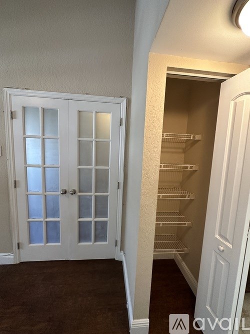 A white door with glass panels is closed.